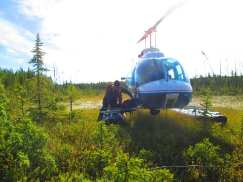 Helicopter picking crew up after a day of uranium exploration in northern Saskatchewan