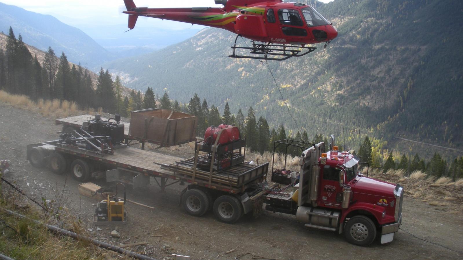 Helicopter mobilizing a drill rig from a semi-truck at the Wildhorse Project in Southeastern British Columbia
