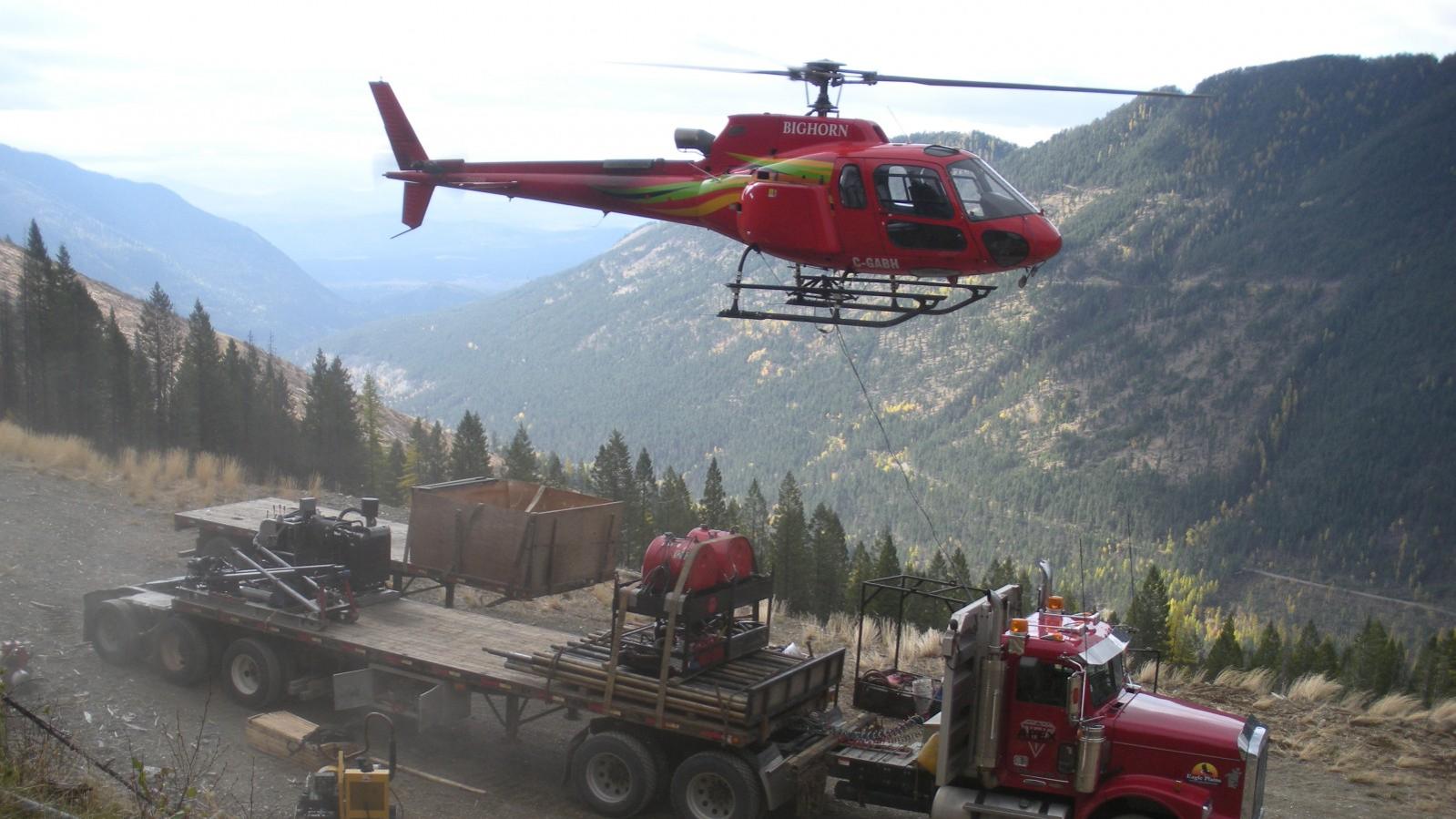 Helicopter mobilizing a drill rig from a semi-truck at the Wildhorse Project in Southeastern British Columbia