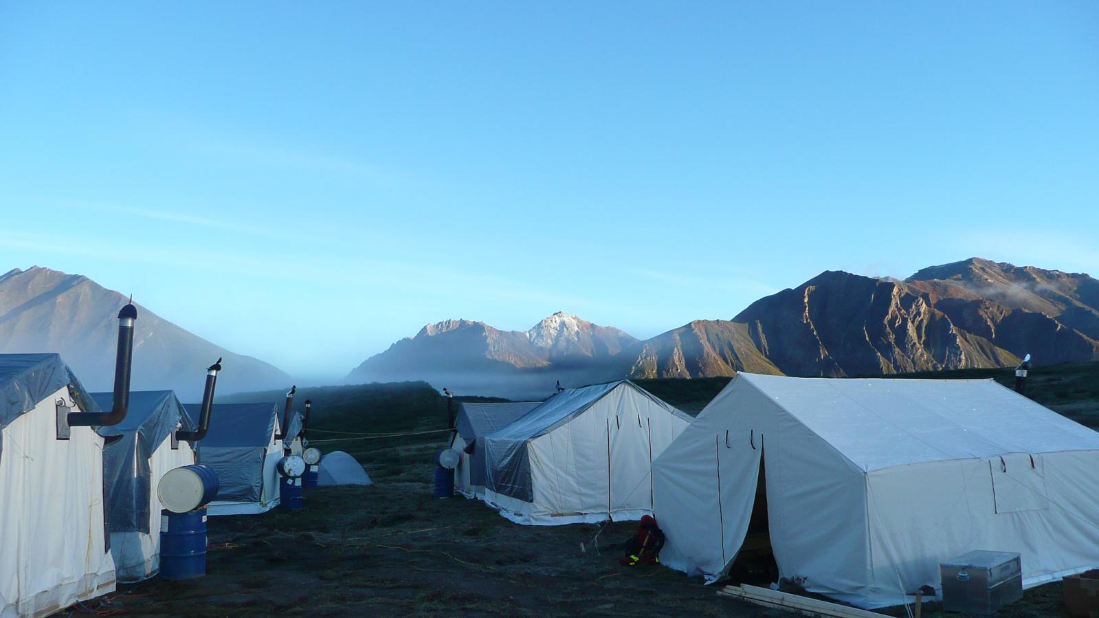 Willowhandle exploration camp wall tents with mountains in background