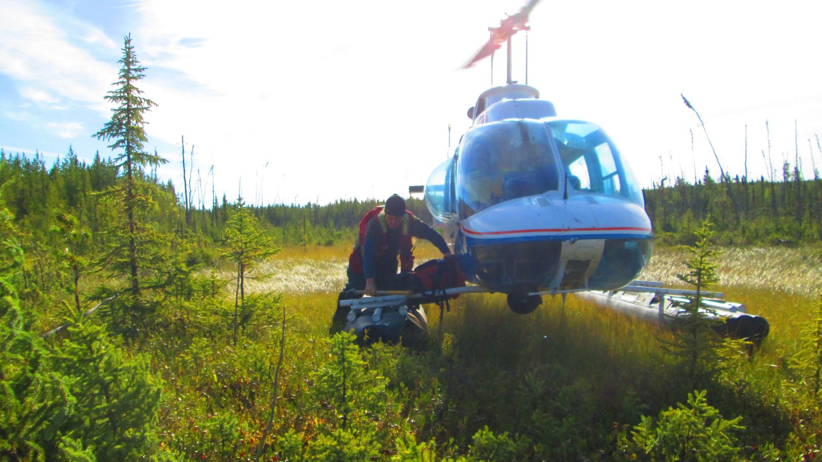 Helicopter picking crew up after a day of uranium exploration in northern Saskatchewan