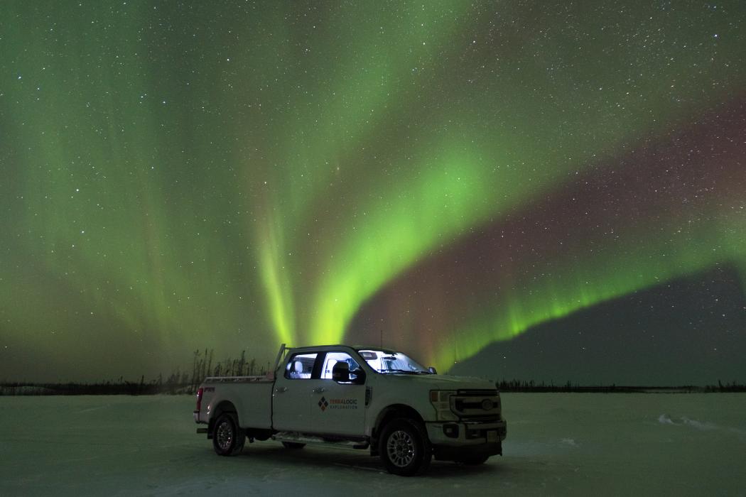 Geology work truck illuminated by the northern lights