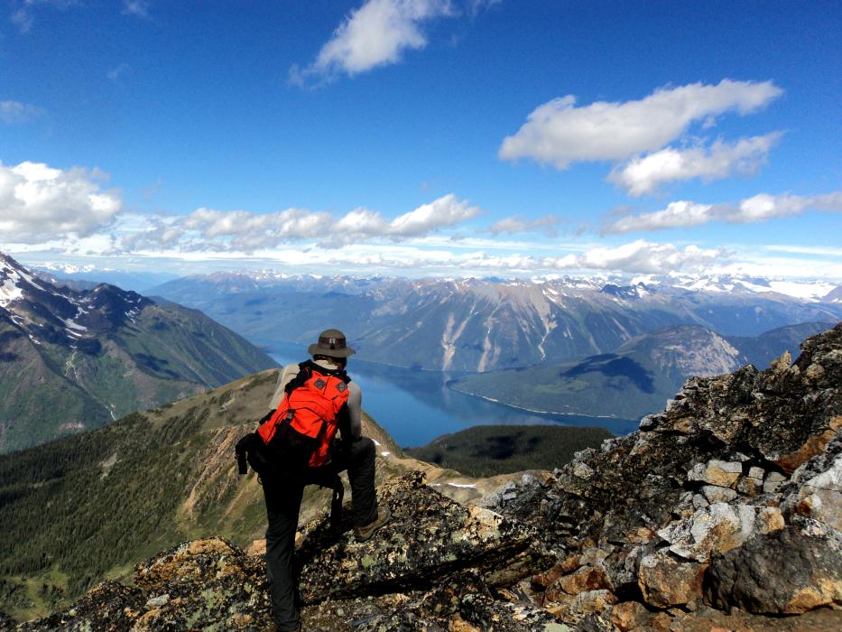 A geologist among the mountain tops overlooking a large lake